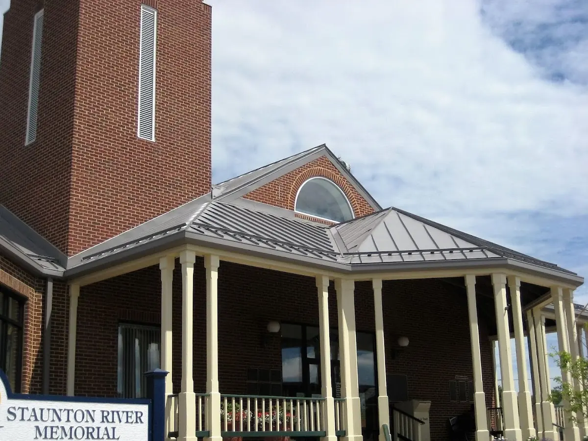 Skilled roofing craftsmen working on a residential roof in Helfrichsville